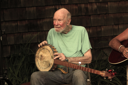 Pete Seeger's iconic banjo bears the words, "This machine surrounds hate, and forces it to surrender." 